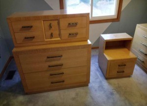 An old fashioned dresser and nightstand.