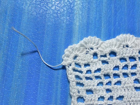 Finishing a crocheted bookmark.