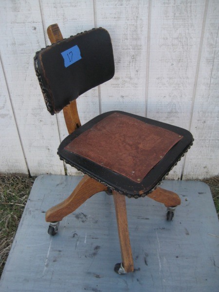 A wooden office chair with a leather seat.