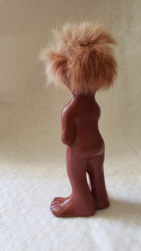 A figurine with a hairy head.
