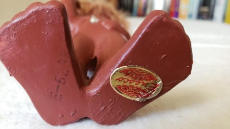 A sticker on the bottom of a figurine.