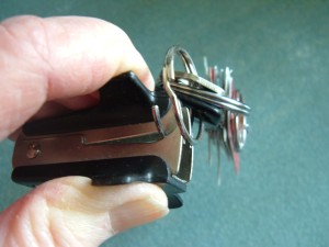 A staple remover used to open a key ring.