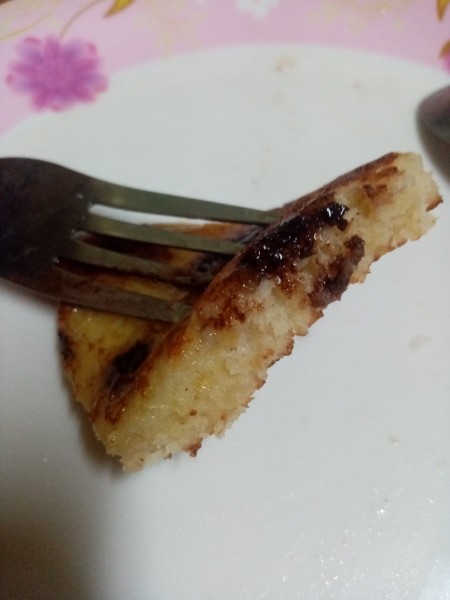 A bite of pancake on a fork.