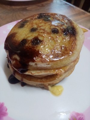 A stack of pancakes with syrup.