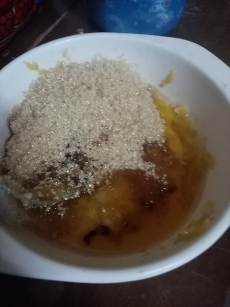 Adding pancake ingredients to the bowl.