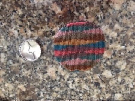 A piece of fabric to cover a button.