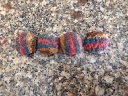 A row of fabric covered buttons.