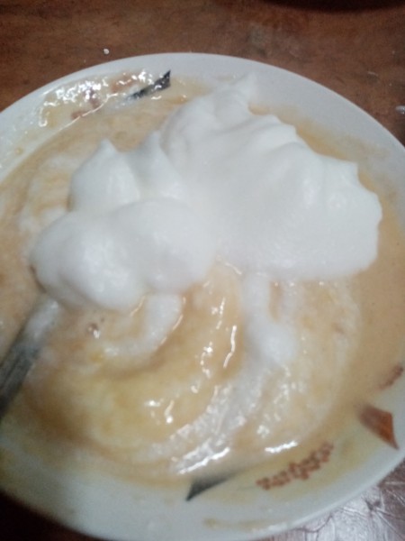 Adding fluffy egg whites to the mixture.