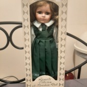 A doll in a green dress, still in the original box.