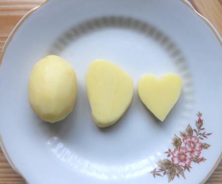 Cutting potatoes in a heart shape.