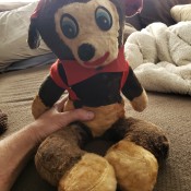 A vintage stuffed animal wearing red.