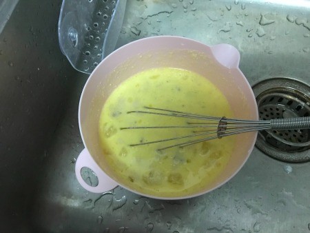 Eggs scrambled in a bowl.