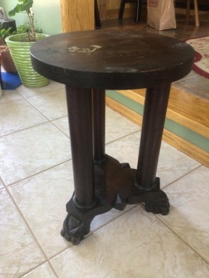 A small end table with three legs.