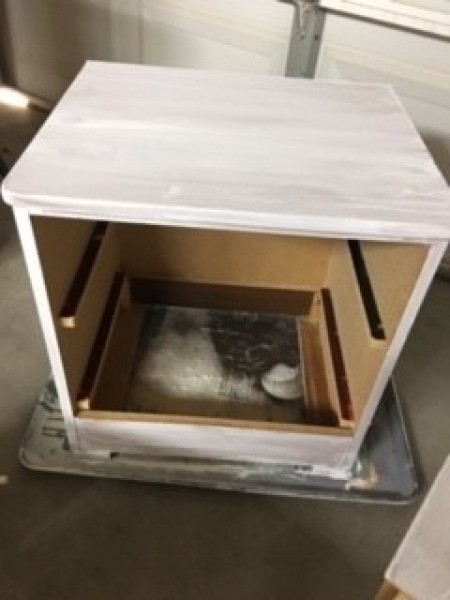 The painted dresser without drawers.