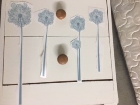 Placing the stickers on the dresser front.