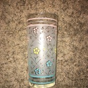 A drinking glass with a floral pattern.