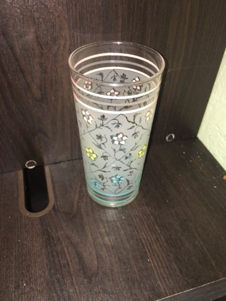 A drinking glass with a floral pattern.