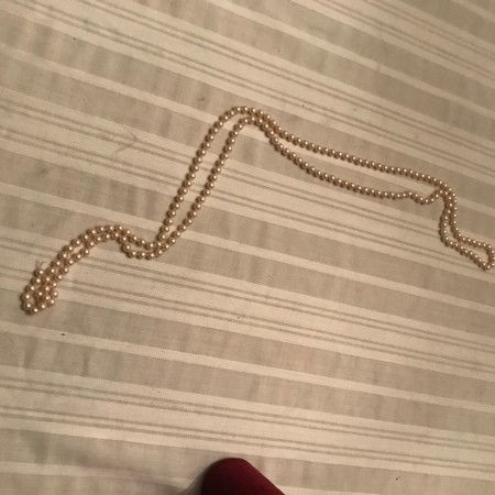 A long strand of golden pearls.