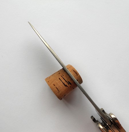 Cutting the end off a wine cork.