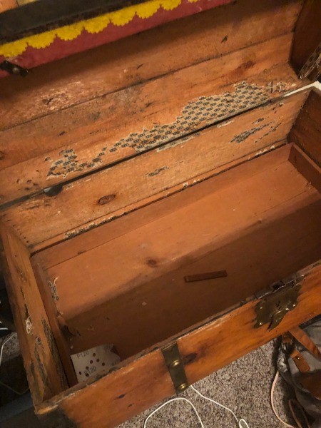The inside of an old trunk.