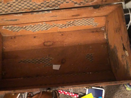 The inside of an old trunk.