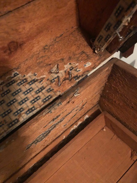 The inside of an old trunk.