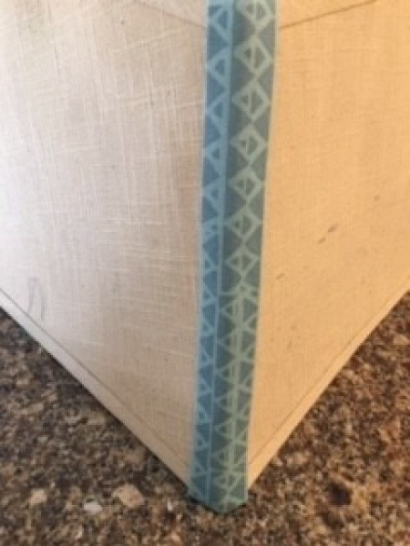 Adding a strip of fabric to the corner of the lamp shade.