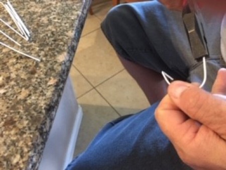 Making loops with a wire hanger.
