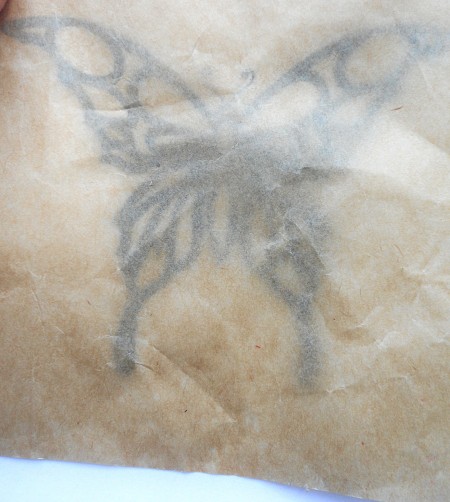 Placing wax paper over the stencil.