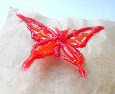 A butterfly drawn from hot glue.