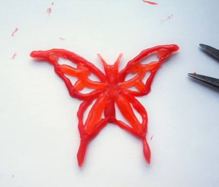 A butterfly drawn from hot glue.
