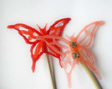Butterflies drawn from hot glue on stakes.
