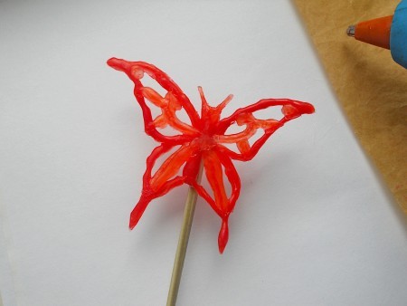 A butterfly drawn from hot glue.