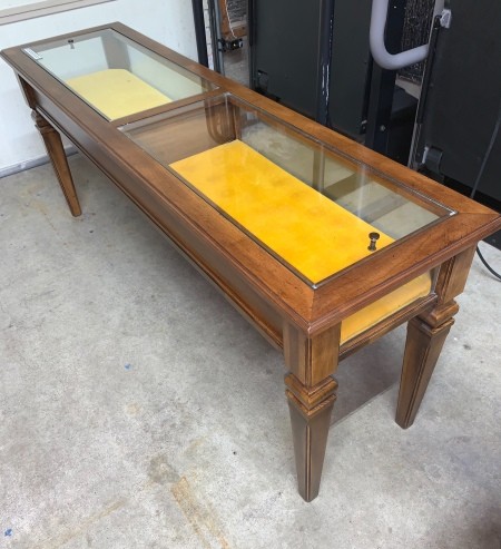 A Brandt display top table with yellow fabric inside.