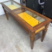 A Brandt display top table with yellow fabric inside.