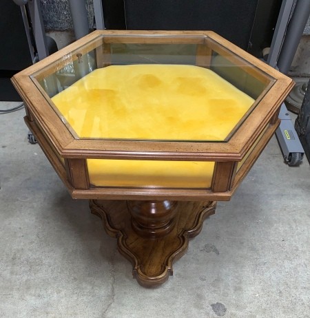 A Brandt display top table with yellow fabric inside.