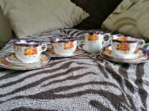 A collection of fine china with painted flowers.