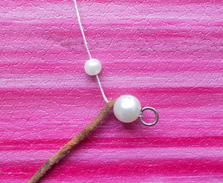Continuing to string the pearls alternated with the leather.