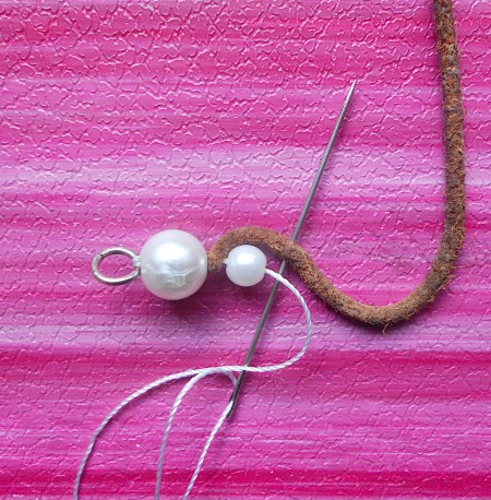 Continuing to string the pearls alternated with the leather.