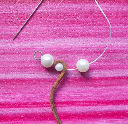 Continuing to string the pearls alternated with the leather.