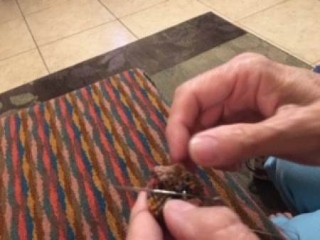 Attaching the buttons to the fabric.