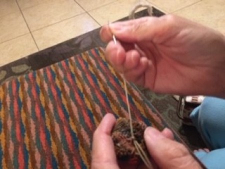 Attaching the buttons to the fabric.