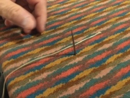 Attaching the buttons to the fabric.