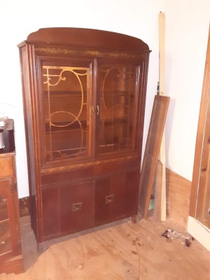 A vintage cabinet with ornate doors.
