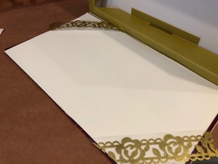 Lace decoration places on either side of the box.