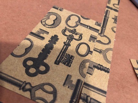 Cutting strips of decorative paper.