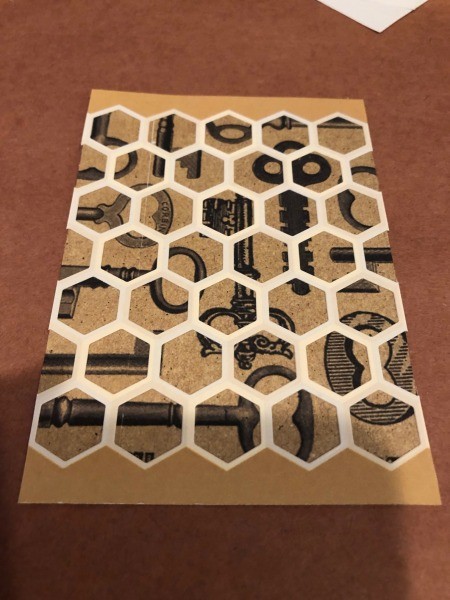 Placing the honeycomb paper over the decorative paper.