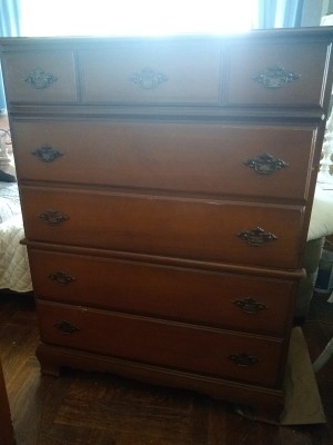A tall dresser with 5 drawers.
