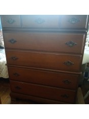 A tall dresser with 5 drawers.