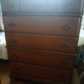 A tall dresser with 5 drawers.